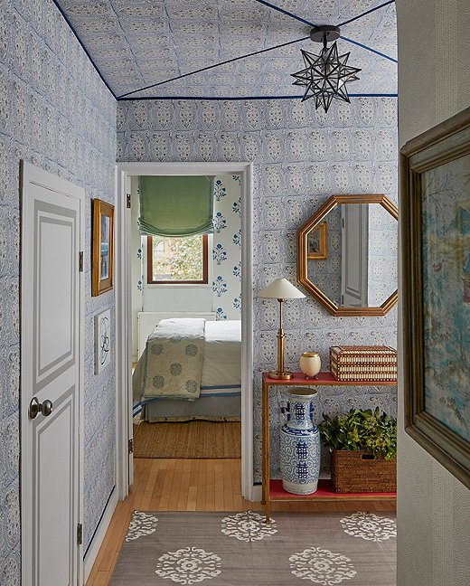 A lively block-print fabric wall treatment brightens up the small foyer, which leads onto the airier bedroom and living room. “I wanted to make it feel like you come through this place of really intense pattern into something really open,” says Lilse. “When you create that kind of dramatic difference it really brings you into the space a bit more, mentally.” She also added interest to the apartment’s basic doors (“they just looked so sad and needed a little help”) with painted faux paneling.
