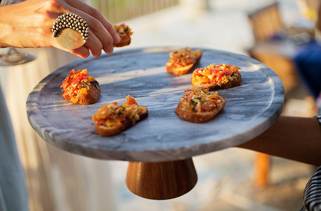 A marble-and-wood cake stand makes a simple yet lovely presentation for fresh bruschetta.
