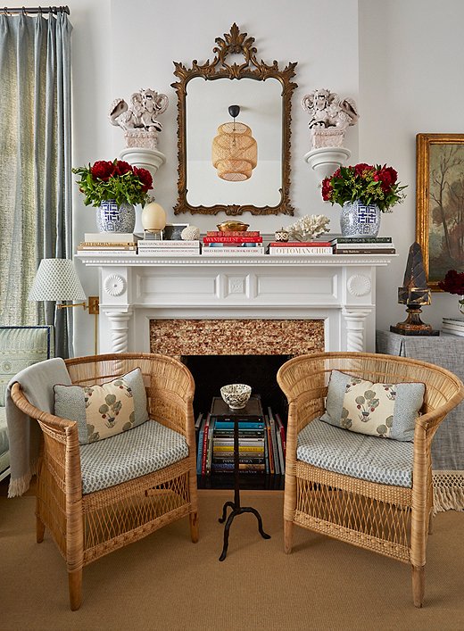 The original fireplace, though no longer functioning, adds tons of historic character to the space. Lilse opted not to change the apartment’s existing white paint job. “The more we added fabric and artwork and furniture into the space, the more I really actually liked this chalky white,” she says. It makes a crisp canvas for artwork and antiques, plus “it has a little texture to it.”

