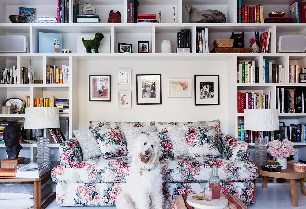 Irene smartly alternates a few gray pillows into the patterned sofa and tucks larger pillows under the side table for extra seating. She scored the pair of vintage Lucite lamps on eBay.
