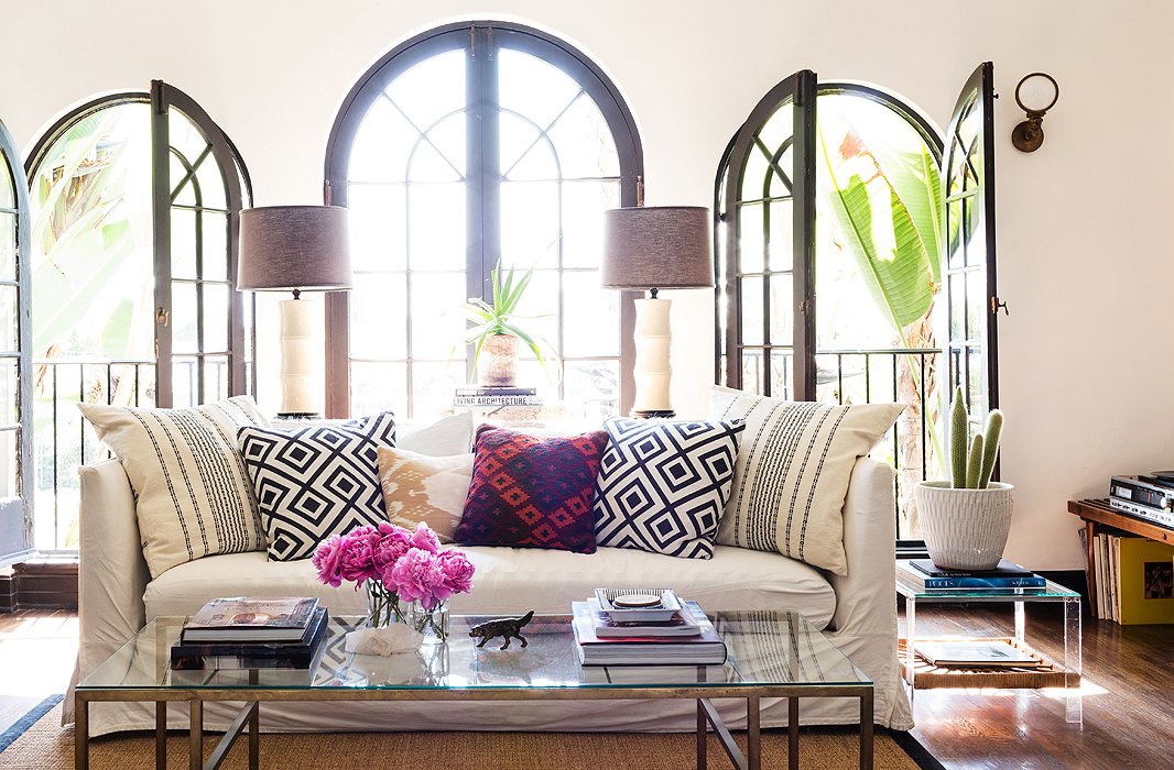 A white slipcover relaxes the lines of this modern sofa, keeping it in sync with the laid-back space. Photo by Nicole LaMotte.
