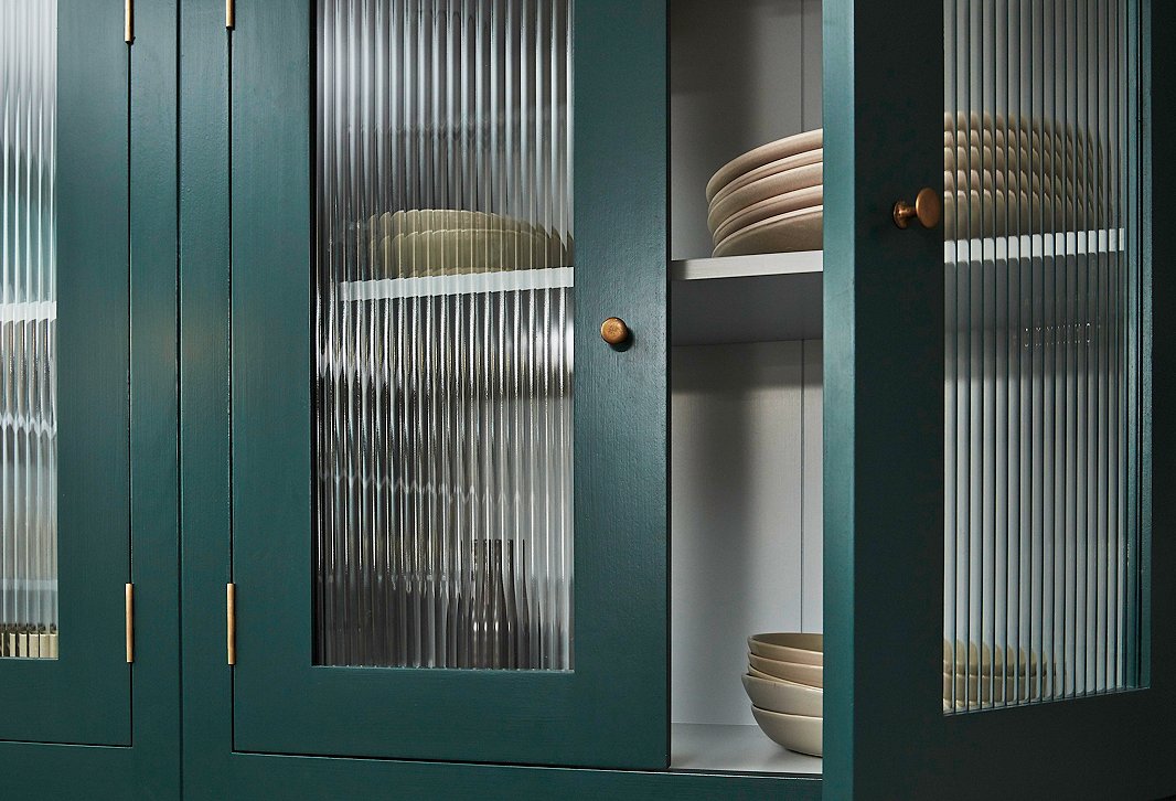 Cabinets with rolled-glass inserts lend lightness to the kitchen while giving the contents a cleaner, more uniform look.
