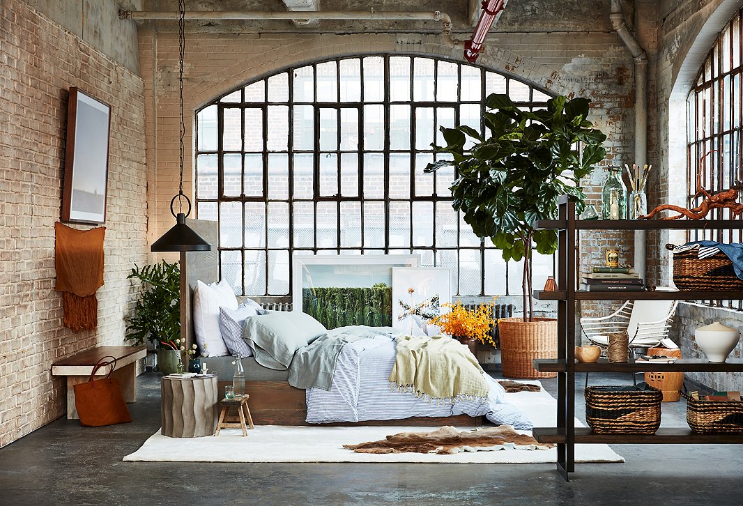 Replace the concrete side table with one of weathered wood, and the room skews more bucolic; replace a few of the woven baskets on the bookcase with chrome-trimmed boxes, and the look is more urban. That’s the beauty of Rustic Sophisticate.
