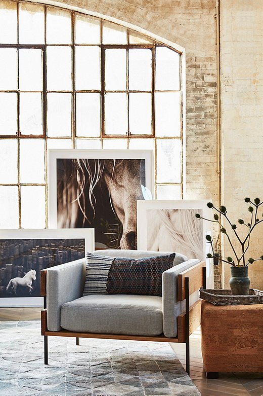 Minimalist silhouettes can often feel cold—but not when rendered in tactile linen and reclaimed oak. Oversize equine photography plays up the rustic element; for a more cosmopolitan vibe, swap in abstract works instead.

