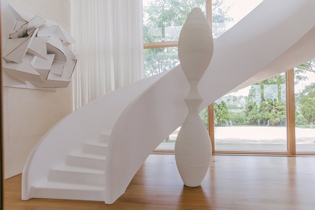 Off the entry is a custom staircase made of snow-white plaster, which Kelly says is incredibly soft on bare feet.

