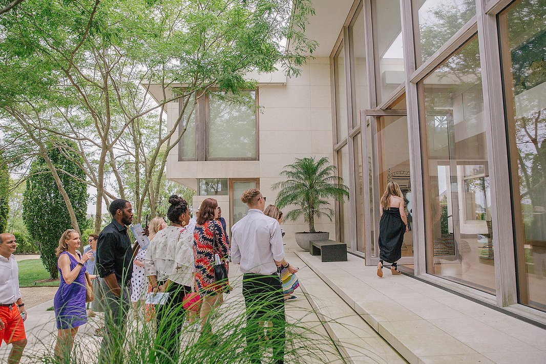 Heading into designer Kelly Behun’s 22,000-square-foot beachfront home. To counter its imposing proportions and glass walls, Kelly sought to create a warm, welcoming ambience, mixing Moroccan rugs and global-inspired fabrics with modern, sculptural pieces.
