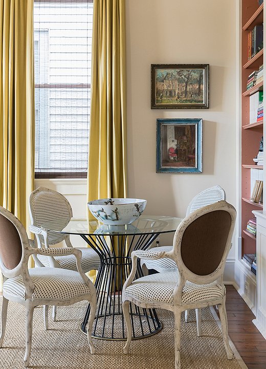 Lemon-yellow drapery in the garden room echoes the colorful walls of Chad’s office, creating a sense of flow throughout the home. The round table often plays host to casual meals with friends.
