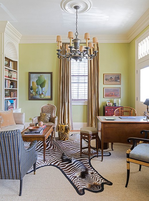 Pale citrus walls amplify sunlight in the space, which Chad often uses as an office.
