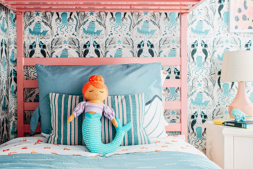 Flamingo-print sheets and mermaid-theme wallpaper offer playful nods to the home’s Sunshine State setting—and when paired with classic stripes and timeless lighting, they manage to look more cute than kitsch.
