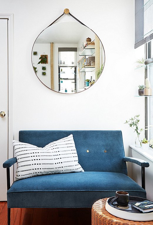 Shown: Vintage settee; round mirror (shop similar here); black-and-white pillow (shop similar here).
