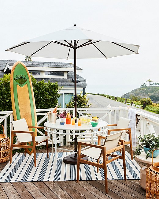The front patio is “where everybody congregates,” Minnie says, whether they’re sitting down to a relaxed lunch in the shade of the umbrella or watching the sun set over the trees. “For me, particularly in the summer, that is the most important spot.”
