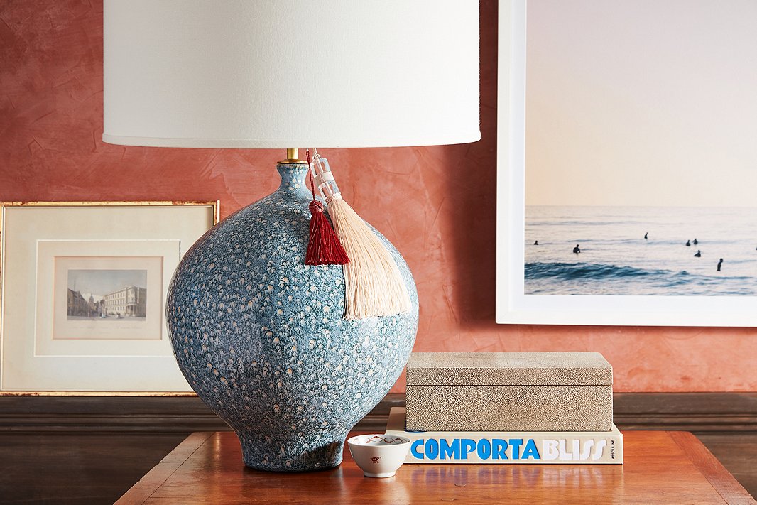 Try doubling up for a layered look. Here, two key tassels—one knotted, one beaded—add some playful texture to a ceramic table lamp.
