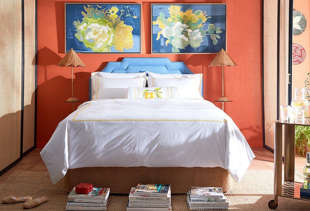 A bedroom dressed in designs by Celerie Kemble, including the exclusive April Duvet and Sheet Set and a pair of woven Parasol Table Lamps. Above the bed, Farmers Market Flowers III and Farmers Market Flowers I help bring the outdoors in.
 
