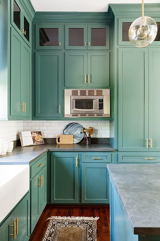 The kitchen was small but got plenty of light, so Elizabeth suggested a daring dark-green paint color. “I loved that my clients took some color risks and stepped outside the box,” says Elizabeth. “It was so fun seeing the kitchen transform.”
