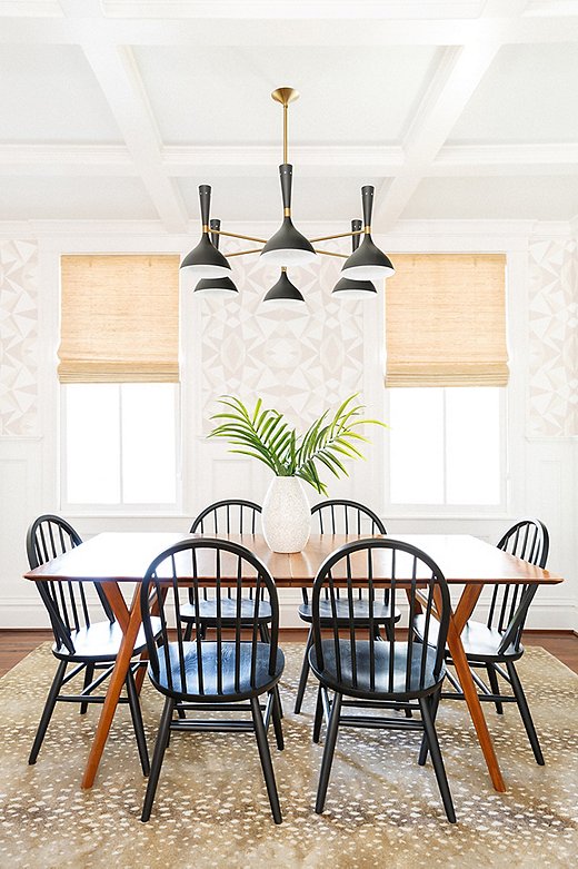 Elizabeth’s penchant for pattern-mixing is on full display in the dining room, where she paired Stark Studio’s Fauna Rug with her own Mosaic wallpaper. “I love mixing larger prints with smaller ones,” says Elizabeth. “The rug is a classic, and we knew we wanted to do something more graphic above the wainscoting on the walls. I love how they are both so neutral but make a great statement.” The black-and-gold chandelier (similar here) adds a touch of mod.
