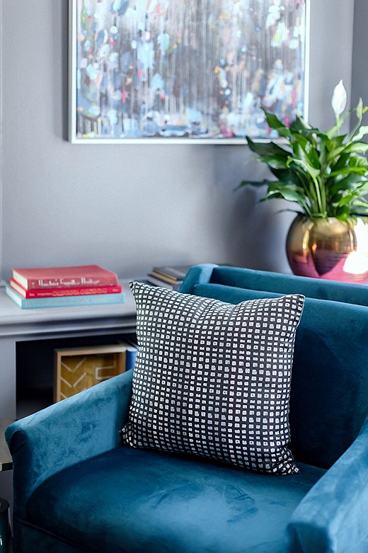 A pillow in Stone Textile Studio’s Color Grid Print fabric tops a teal-velvet accent chair found on One Kings Lane.
 
 
