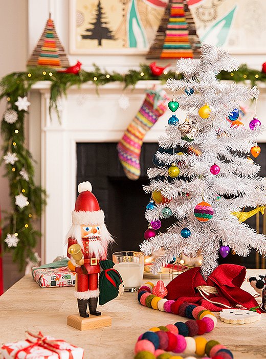 A holiday-hued fabric draped around the base of the kids’ trees adds grown-up polish.
