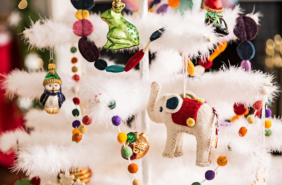 Try a mix of ornaments–let family heirlooms live among kid-friendly favorites like animals and gingerbread men. Felt options, like this elephant, are safe for even the littlest hands to hang.
