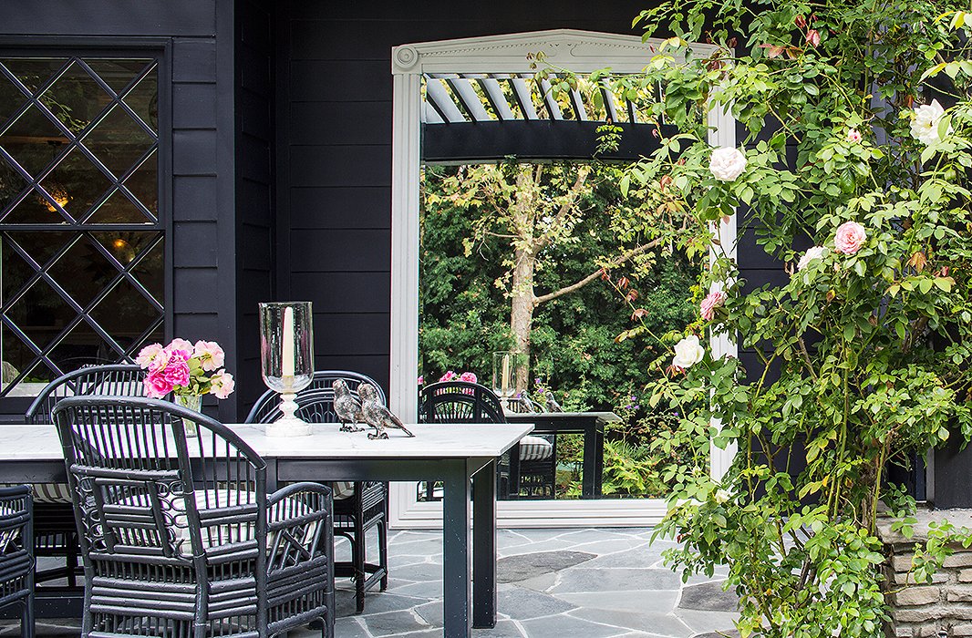 An oversize mirror dresses up the outdoor dining space of designer Windsor Smith’s L.A. abode.
