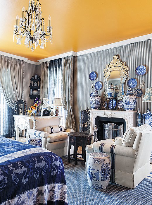 In Michelle’s Dallas master bedroom, a blue-and-white palette unifies all manner of prints and patterns, from classic ticking stripes to large-scale ikats.
