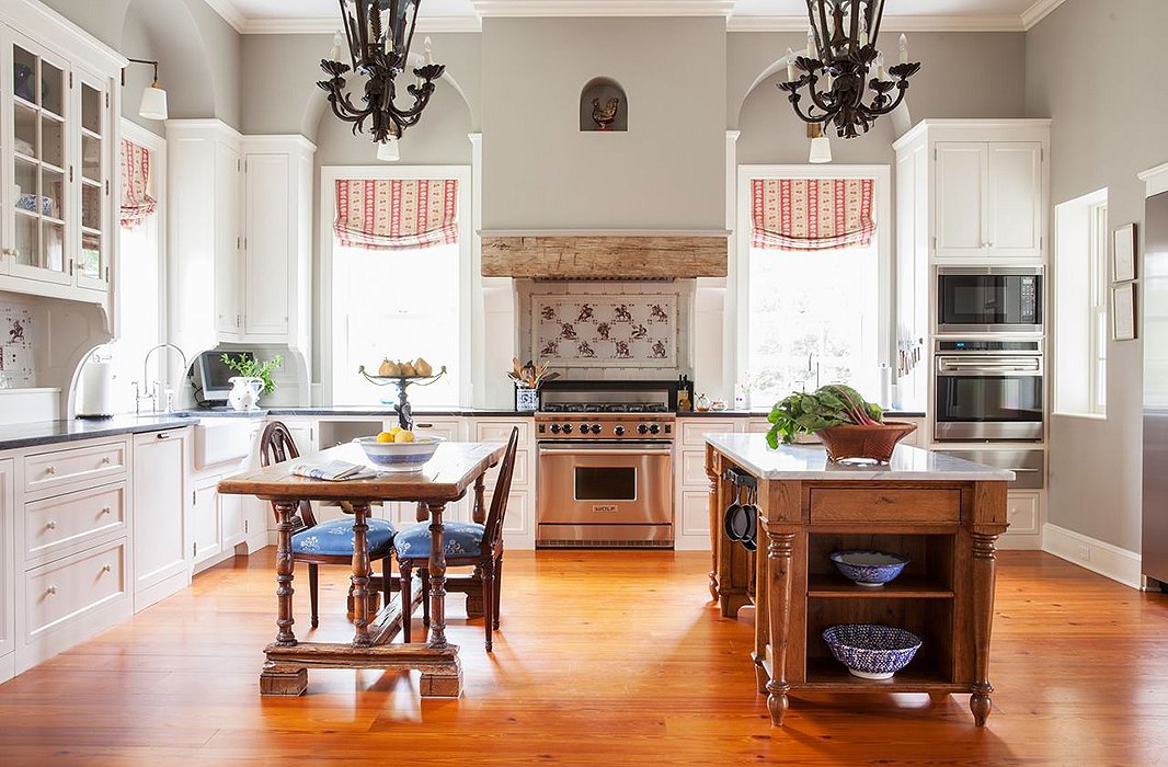 Can’t find the pot rack? It’s attached to kitchen island. Other farmhouse elements include a butler’s sink, a wood beam obscuring the range hood, and the traditional wood table, chairs, and island. Yet this kitchen is as sophisticated as it is rustic—the best of both worlds. Photo by Lesley Unruh.
