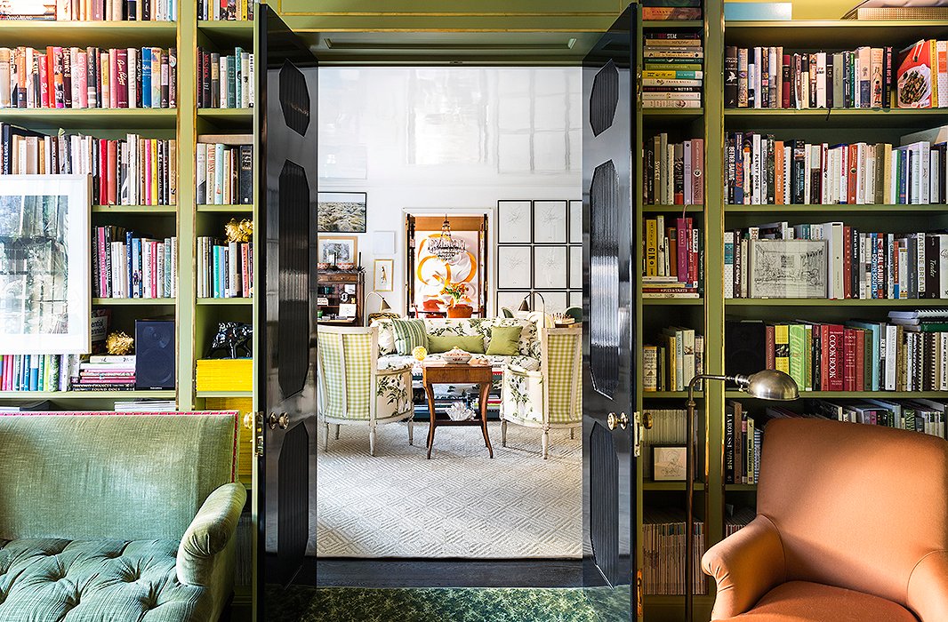 Purchased at auction, an orange wool chair in the library ties in nicely with the dining room’s color scheme. “I brought it home and I thought I’d recover it,” says Kate, “and then I put it in the library and I thought…well this is meant to be. It balances the orange in the dining room and it sparks it up a bit—it was sort of a happy accident.”
