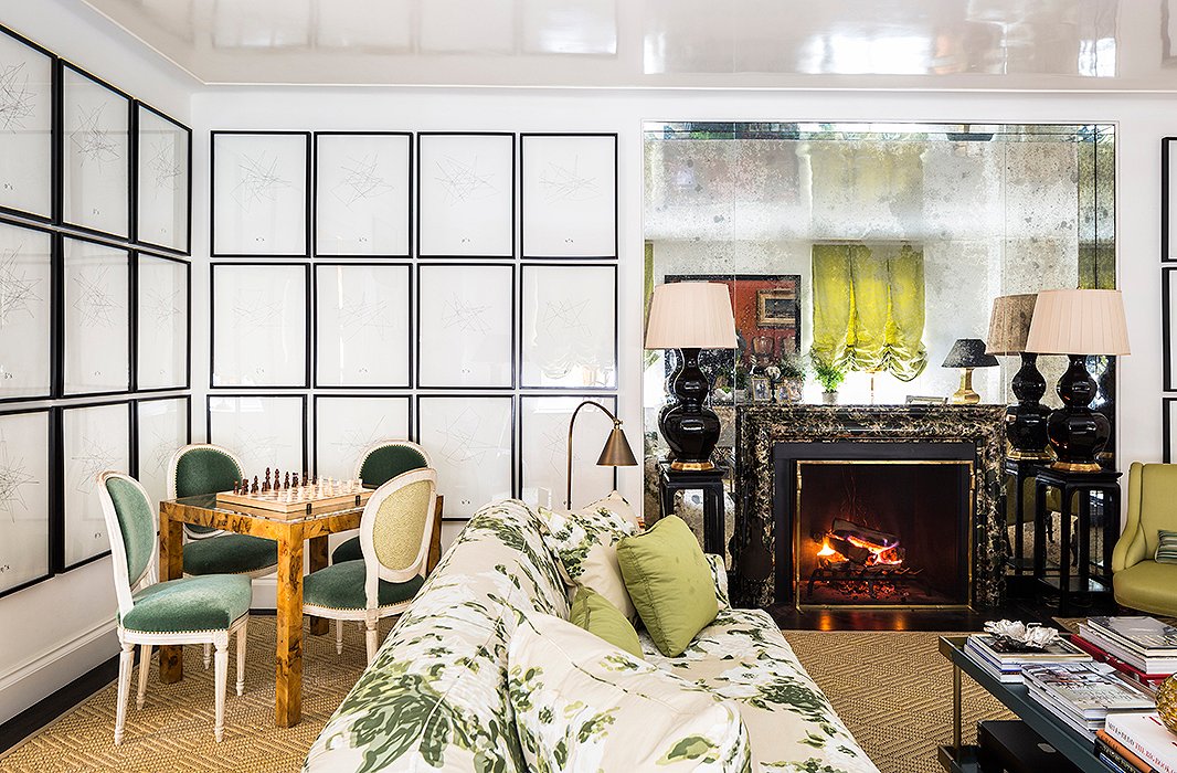 Framing a living room fireplace, lacquered Ming-style side tables support a pair of oversize gourd lamps. Photo by Lesley Unruh.
