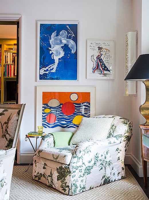 A roll-arm chair covered in the room’s signature chintz serves as Alex’s choice spot for a Saturday afternoon nap. Artwork by Alexander Calder and James Narse brings a touch of the modern to the otherwise traditional vignette.
