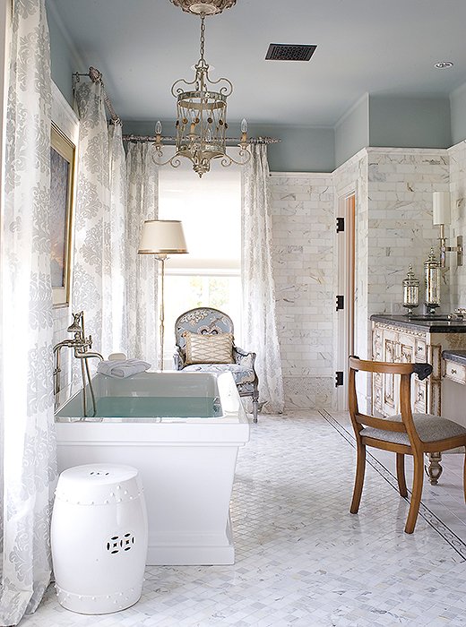 Love the elegant lighting and seating in this master bathroom