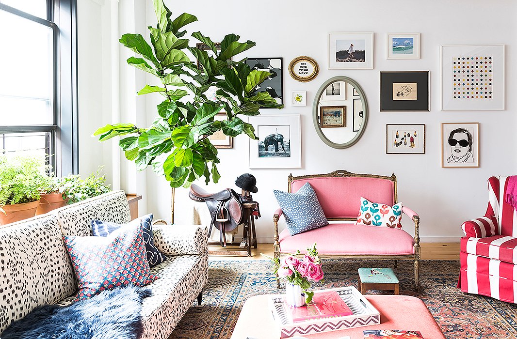 In a living room corner, a custom-made saddle by Berney Bros. sits atop a stitching horse, both of which belong to Kate’s husband, Chris. “It’s a nice moment in the apartment,” she says. “Everything in that corner is his, and they all live together. It just so happens that they’re beautiful to look at too.” The eclectic gallery wall includes an Arthur Elgort photograph of Kate Moss riding an elephant, Damien Hirst’s Spots, and vintage finds. 
