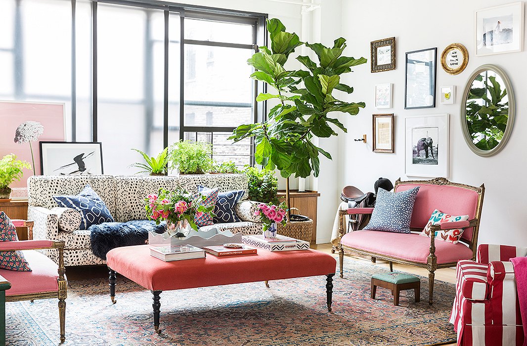 Two settees found at auction were recovered in coral Belgian linen by Kravet. Between, a custom ottoman from John Derian contrasts ever so slightly with the dusty-pink rug below. Layering colors and patterns, even if they’re similar, “creates richness,” Kate says. “There are all these different shades, one on top of another, but they bring out the best in each other… like a painting.” 
