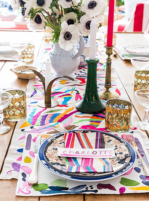Kate likes to layer for tea, but she’s not one for a tablecloth. Dishes are usually stacked (one vintage, one new) atop place mats—these were inspired by Pierre Frey napkins. The embroidery, found by her mother while traveling in Tulum, guides the eye to ceramics and candlesticks that “are just as important as the flowers.” Kate purchases colorful beeswax tapers from Paris and eBay packs at a time to coordinate with whatever blooms she has on display. 
