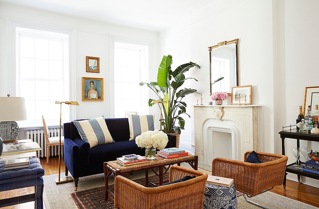 The starting point for the design was the navy settee. “I love the classic features of it—the wooden legs and, of course, the color—but the clean lines and the very rectangular angles just felt so fresh,” Amy says. The walls were painted Benjamin Moore’s Chantilly Lace.
