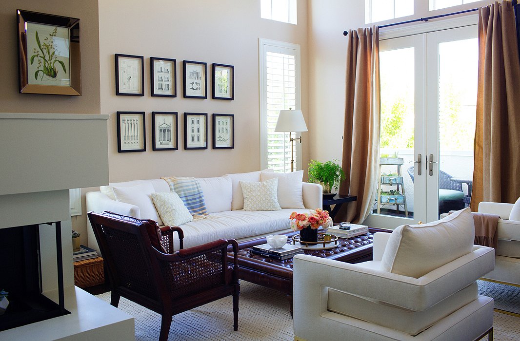 While Louise isn’t one to shy away from bold colors and prints in her wardrobe, her home needed to be a comfy and calming counterpoint. Cue the furnishings in creams, dark woods, and rich leathers, which include white club chairs and a sofa found on One Kings Lane.
