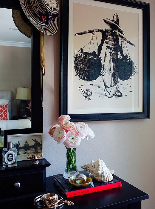 Hanging above the dresser, where catchalls hold everyday and costume jewelry, is one of two sketches that belonged to Louise’s grandmother. “They’re from Brazil and my granny owned them for 50, 60 years, and I brought them out from England and reframed them,” Louise explains.
