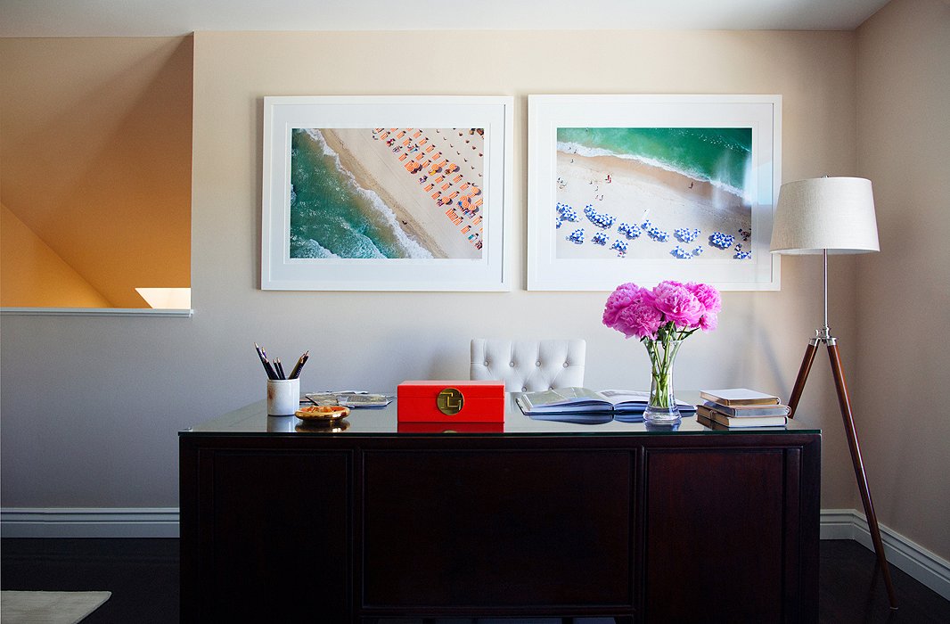 In Louise’s mezzanine office, where she does all her writing, sunny prints by Gray Malin and a large rosewood desk take center stage. “I like how sturdy and big it is,” she says. “It reminds me of my dad’s desk when I used to go and sit in his office when I was little.”
