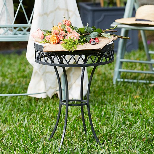 Topped with marble and powder-coated a rich charcoal gray, this wrought-iron accent table is a garden-party standout.

