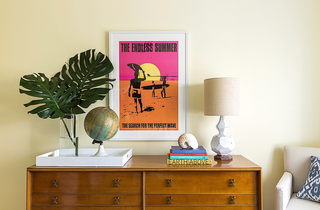 A colorful movie-poster print of one of Matthew’s favorite surf documentaries, The Endless Summer, hangs above a vintage Paul Frankl dresser in the guest bedroom.
