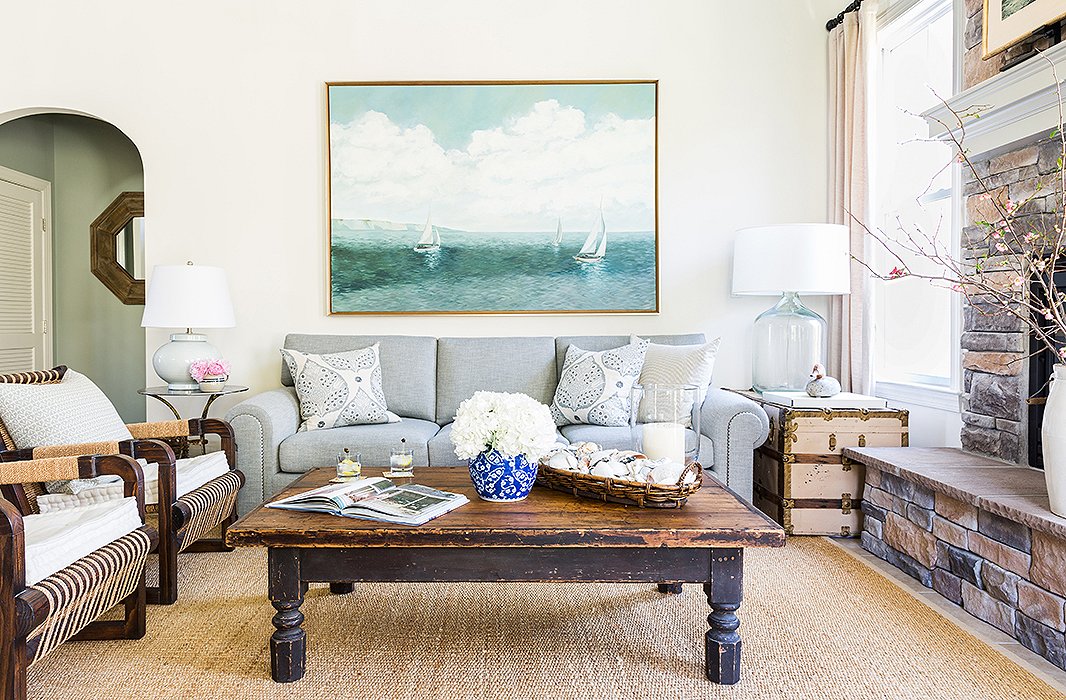 The family room is anchored by an old worktable salvaged from a barn and “cut down to cocktail-table height,” while the large seascape is one of several paintings in the home by Matthew. “I’m the oldest of three, and we all painted growing up,” says Matthew, adding with a smile, “My father always wanted a fine artist in the family, but he still hasn’t gotten one.”
 
