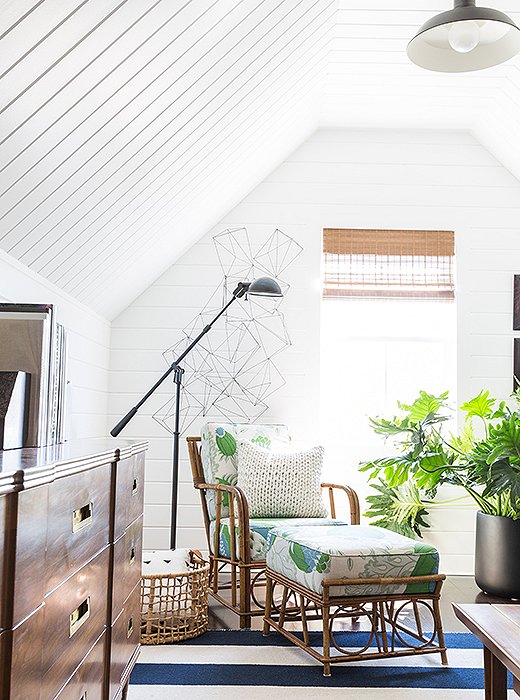 Matthew reupholstered the rattan chair and ottoman in a lush Christopher Farr floral fabric (“It’s one of my favorite prints”), which is nestled alongside the Equilibrium floor lamp from Ralph Lauren Home and a midcentury dresser by John Widdicomb.
