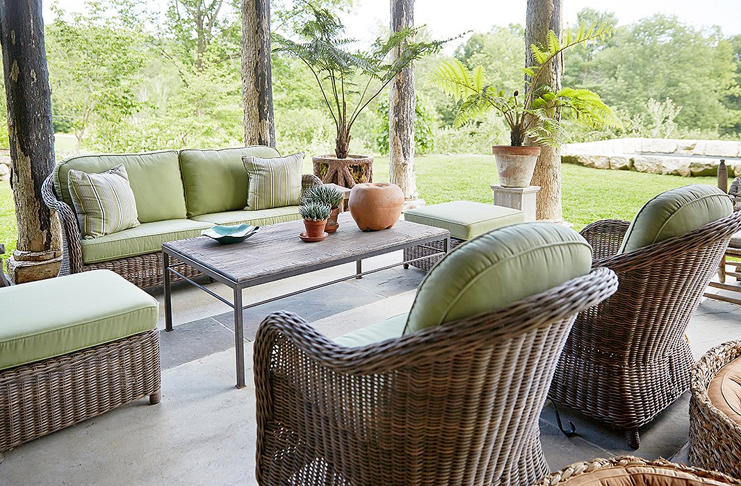 So as not to distract from the idyllic natural surroundings, Bunny maintained an organic feeling with unglazed pots, a bamboo coffee table, and pale-green-cushioned wicker lounge seating by the Belgium maker Vandecasteele Marc & Co.
