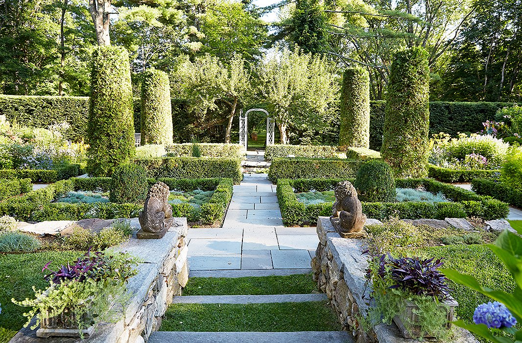 “This is the garden that John and I see from the porch,” says Bunny of the sunken garden, which is anchored with a koi pond. “I had a stone wall built to terrace the land. You have the sensation of moving from one space to another as you walk down the six big, wide steps that lead to the garden.”
