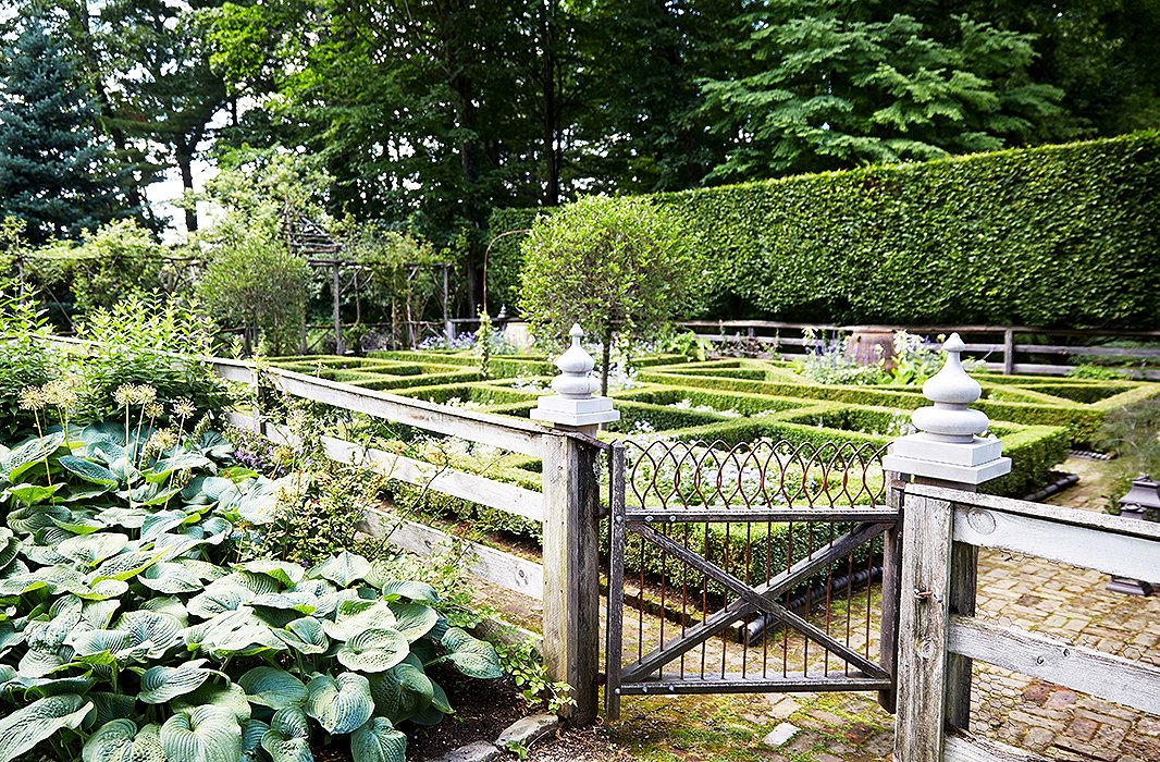 Bunny’s formal garden, lined with 12-foot-high hornbeam hedges, is ever-changing, with new combinations of colorful blooms planted each year. Planning begins in winter, when she and John sketch it all out.
