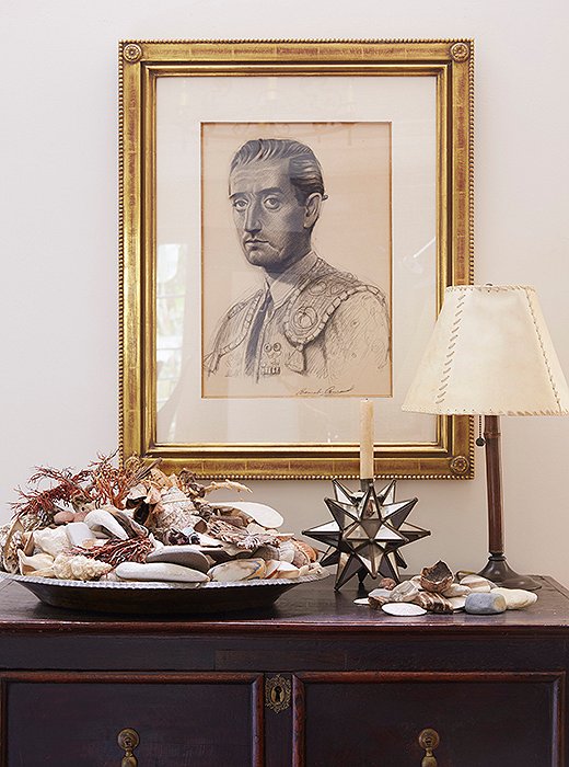 Kendall’s father, an artist, sketched the portrait of a matador. Shells from family trips spill out of a silver tray. “Some are from the Maldives, Hawaii, Majorca—we always bring some back,” Kendall says. The chest is Spanish and conceals the television.
