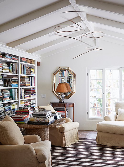 The built-ins of the library hold many of the things that inspire Kendall and her designs. “Everything gets in,” she says. “Photography, fashion, sculpture, nature.” The woven pedestal table is from William Laman. Also tucked in the shelves are her father’s matador’s hat, an Egyptian Coptic cross, and a leather box made by Kendall.
