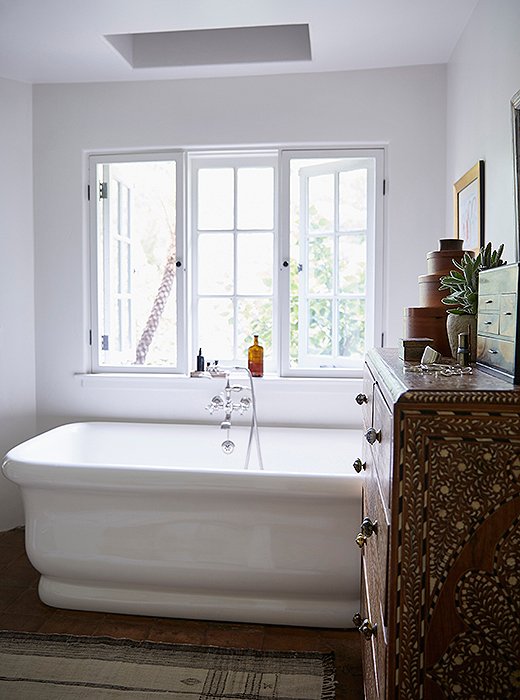 “I spend a lot of time in this tub,” says Kendall. “To me, the ultimate luxury is a hot bath with salts and essential oils.” The designer logs a lot of reading time here thanks to the natural light streaming from the window and skylight. The tub and fixtures are by Waterworks. Another vintage Moroccan rug covers the floor.
