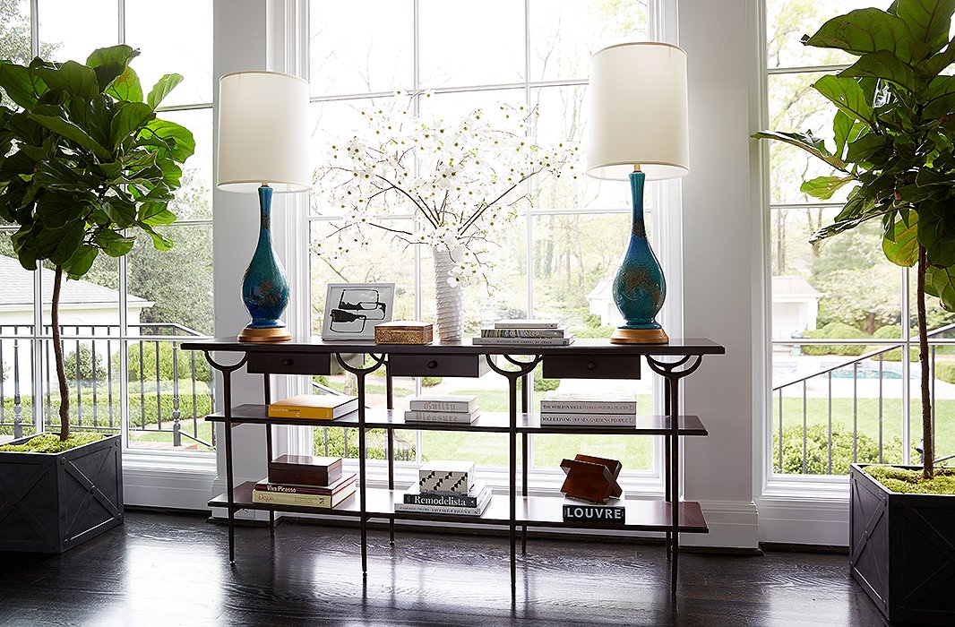 The open lines of this credenza allow plenty of natural light to flow in while giving space for coffee table books and favorite objets.
