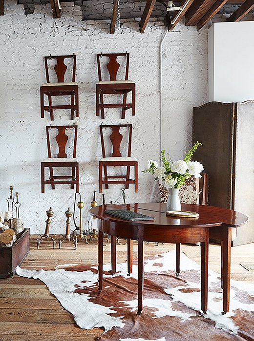 Darryl has a keen eye for clean lines, even in antiques. Case in point: this pair of circa-1810 Hepplewhite demilunes from England and the set of late 19th-century dark-cherry dining chairs discovered in Philadelphia.
 
