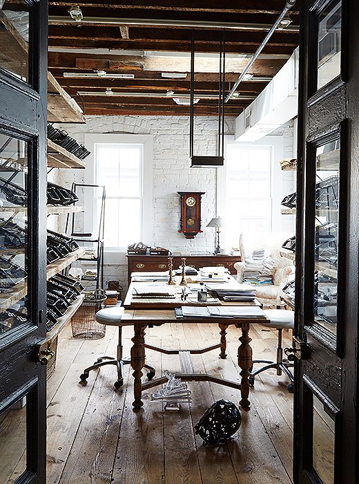 Reclaimed wood doors open to the shop’s fabric library on the first floor. Swatches are arrayed throughout and fill metal bins originally used to sort military mail during World War II. “The bins sat in storage for years before we found the perfect use for them,” says Darryl, who discovered them at an L.A. salvage yard.
