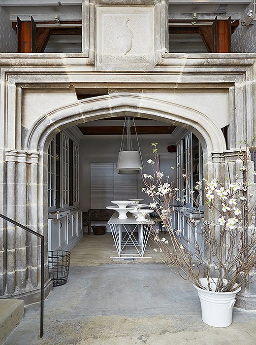 In the shop’s entry, poured concrete floors pave the way to a grand greeting: a limestone arch salvaged from a manor house on the Potomac River.
 
